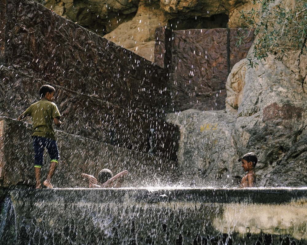 Children playing in the Nizwa Hot Springs in Oman